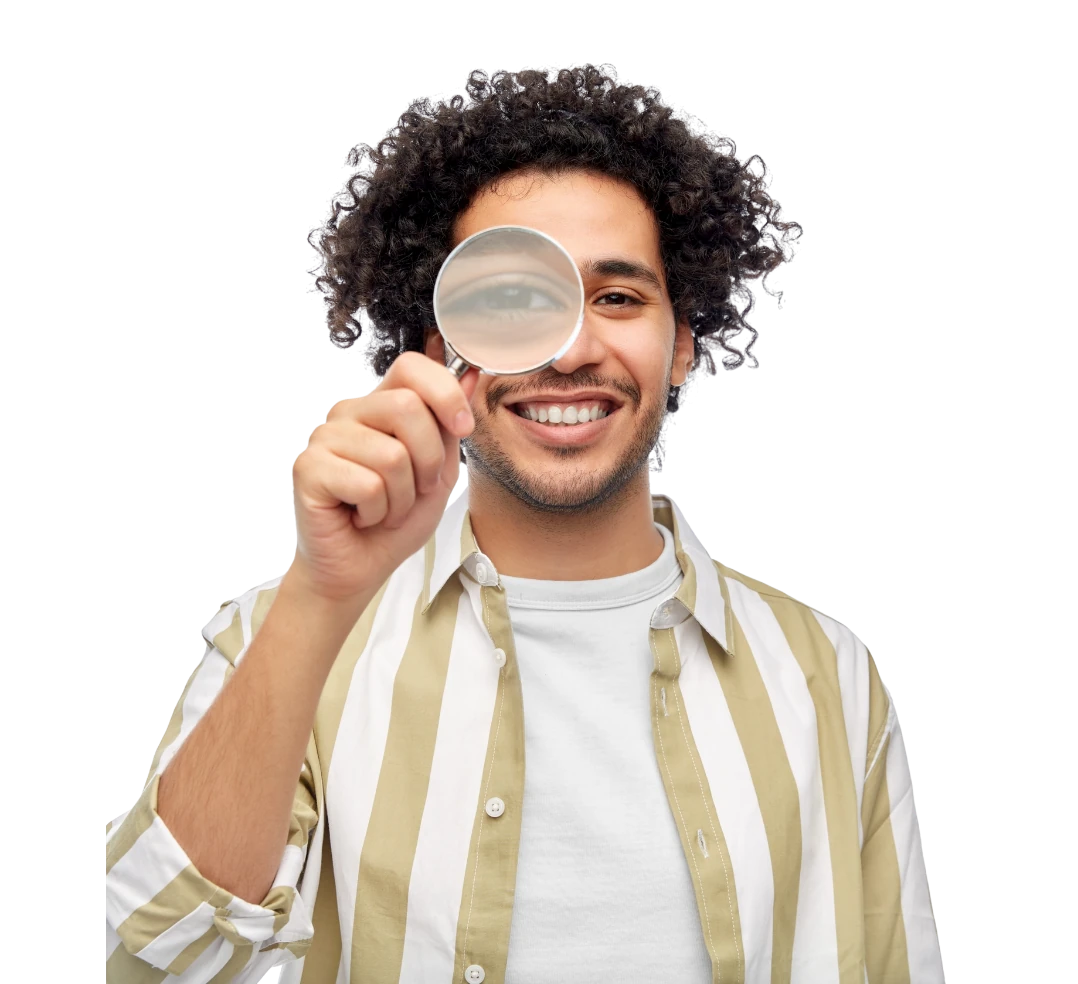 Smiling man looking through a magnifying glass